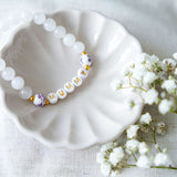 Handmade mummy bracelet with white gemstone beads and gold letter beads spelling MUMMY, a thoughtful handmade jewellery gift for mums and Mother’s Day.