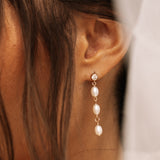 close up of kya pearl drop earrings with cubic zirconia stone 