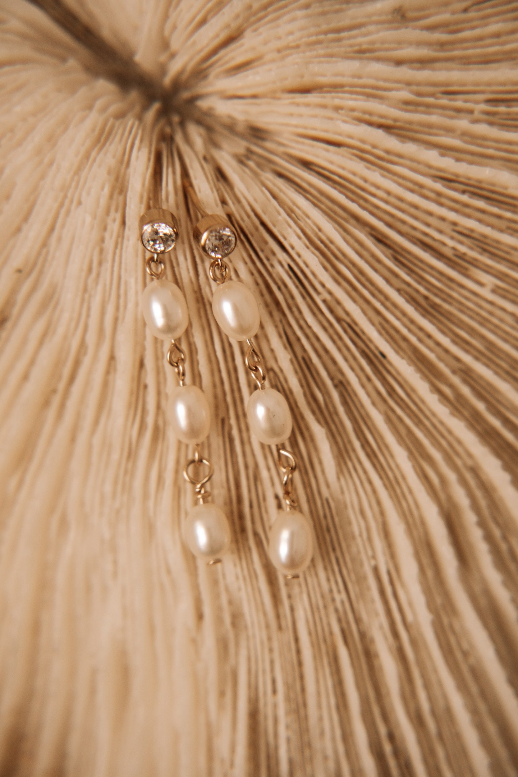 Close up dangling cubic zirconia and rice pearl earrings