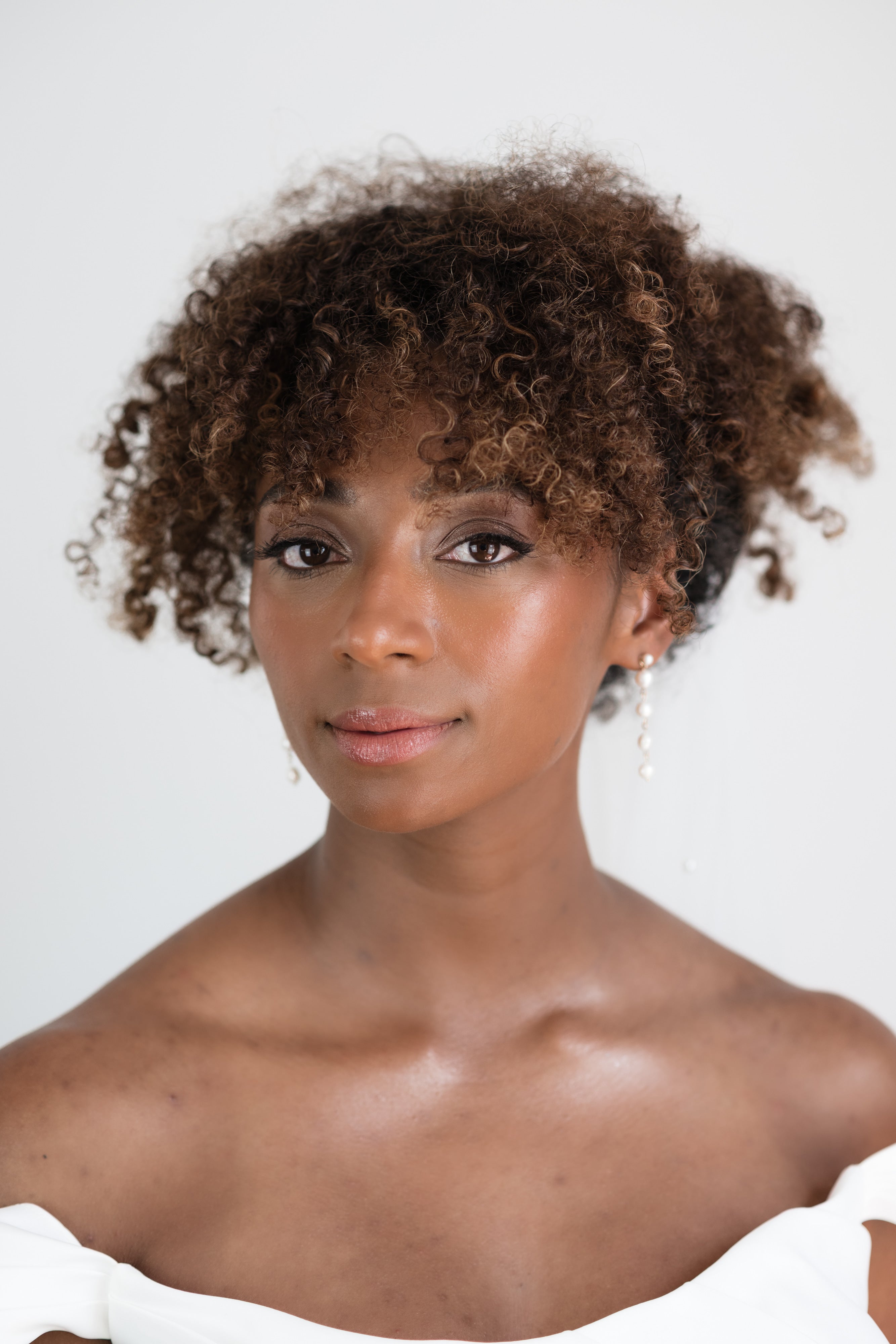 Styled pearl earrings on bride