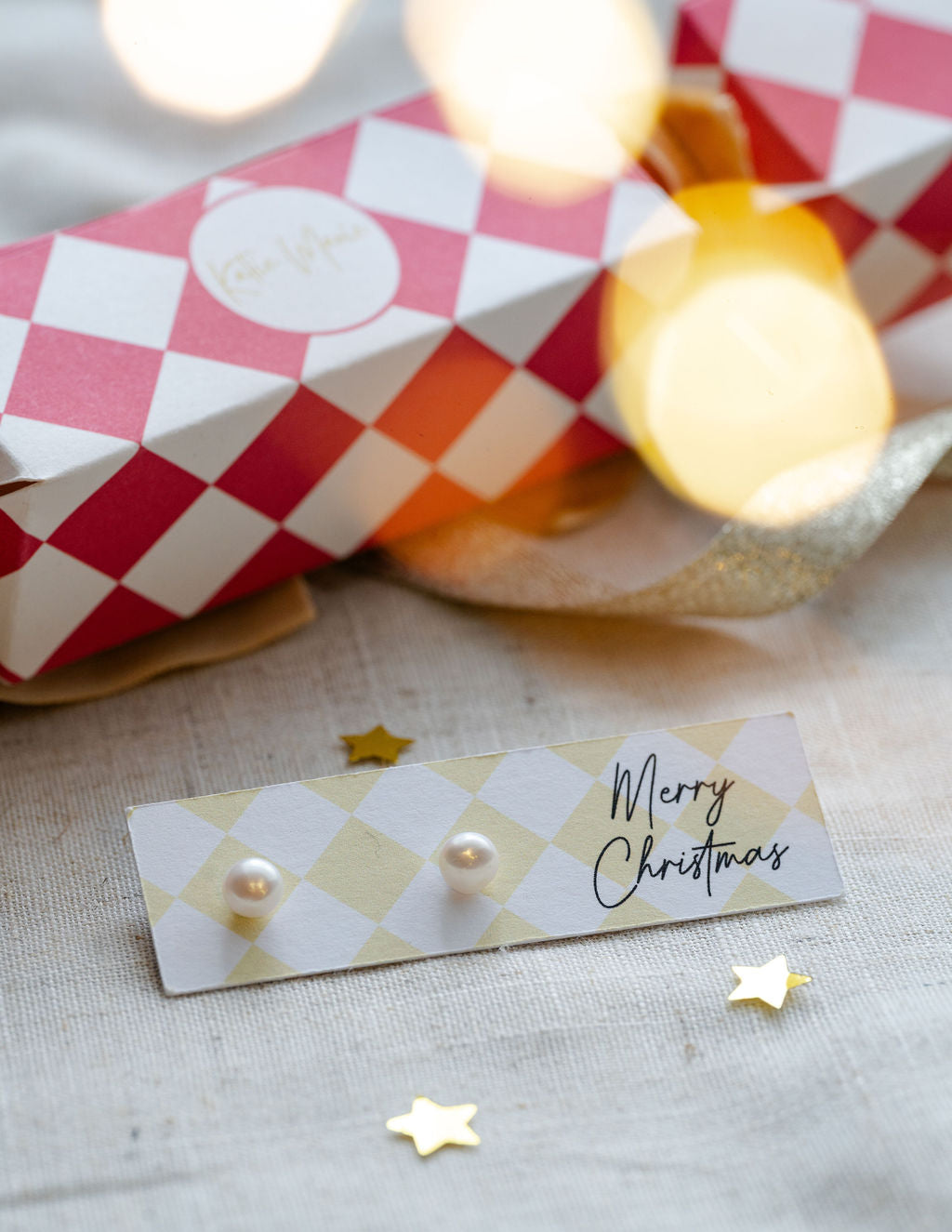 pearl earrings studs on merry christmas stationary. 