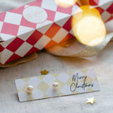 pearl earrings studs on merry christmas stationary. 