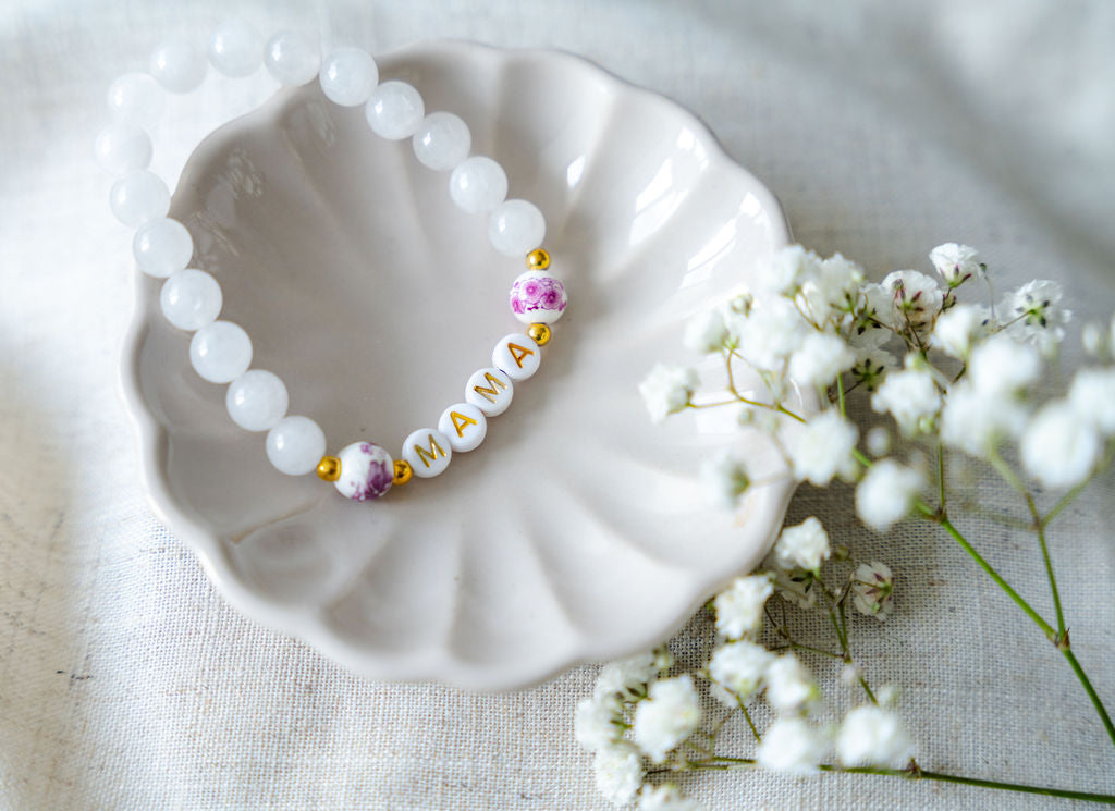 Handmade mama bracelet with white gemstone beads and gold letter beads spelling MAMA, a thoughtful jewellery gift for new mums or Mother’s Day.
