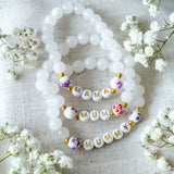 Handmade beaded bracelets with gold letter beads spelling MAMA, MUM and MUMMY, thoughtful jewellery gifts for new mums and Mother’s Day.