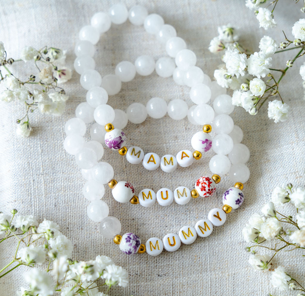 Handmade beaded bracelets with gold letter beads spelling MAMA, MUM and MUMMY, thoughtful jewellery gifts for new mums and Mother’s Day.
